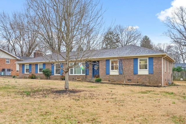 ranch-style house featuring brick siding, a chimney, roof with shingles, crawl space, and a front yard