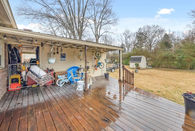 wooden deck featuring a storage shed, a lawn, and an outdoor structure