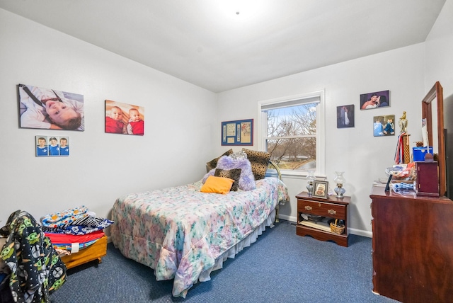 bedroom with carpet floors and baseboards