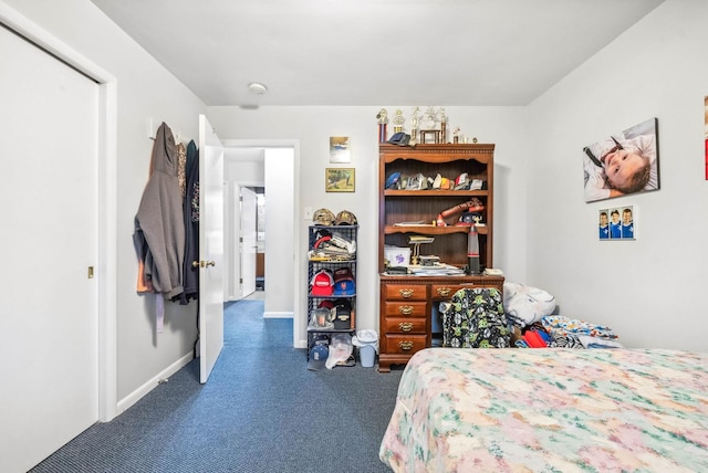 bedroom featuring carpet and baseboards