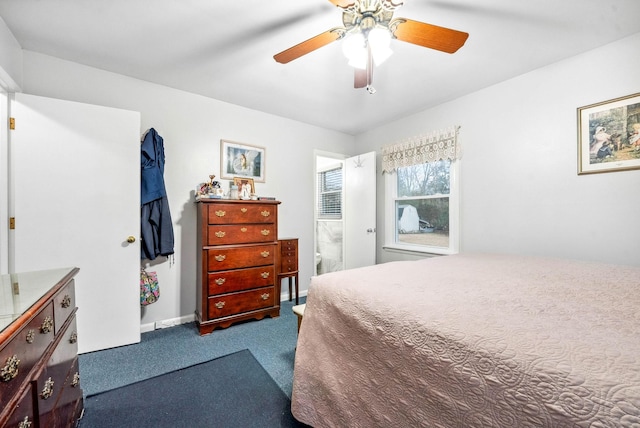 carpeted bedroom with ceiling fan and baseboards