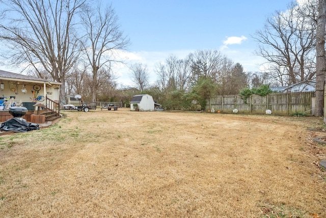 view of yard with an outdoor structure and fence