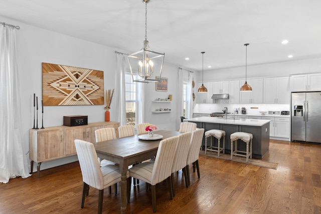 dining room featuring wood finished floors and recessed lighting