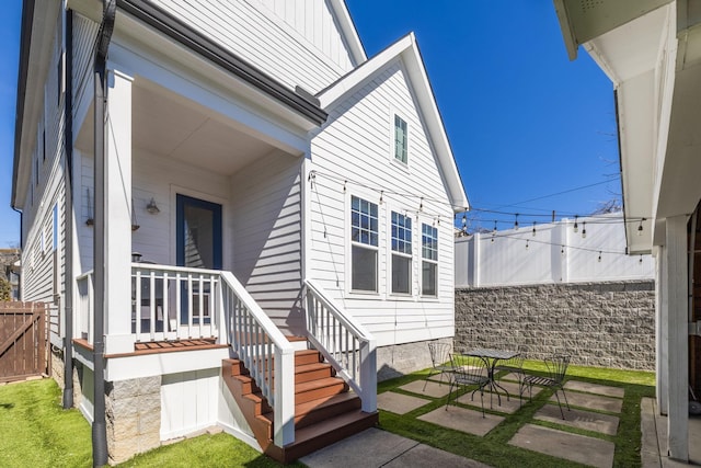 doorway to property featuring a patio and fence