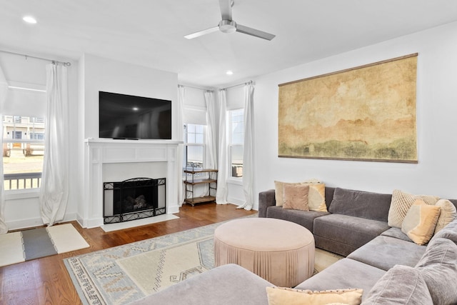 living area with plenty of natural light, a fireplace with flush hearth, wood finished floors, and recessed lighting