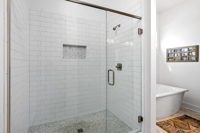 bathroom with a freestanding bath and a stall shower