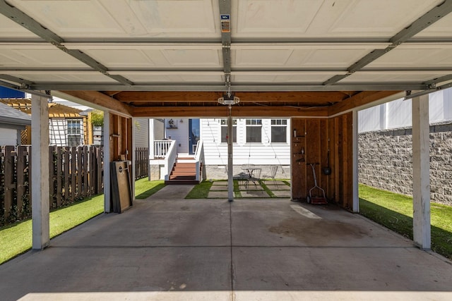 garage with fence and a garage door opener