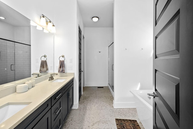 bathroom featuring a freestanding bath, double vanity, a stall shower, and a sink