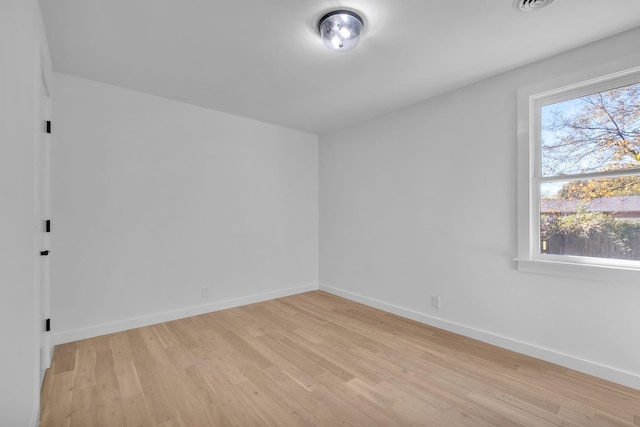 empty room with light wood-style floors and baseboards