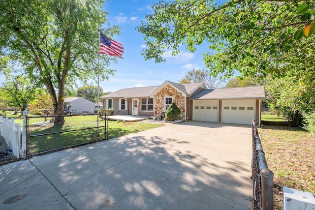 ranch-style house featuring stone siding, an attached garage, fence, and driveway