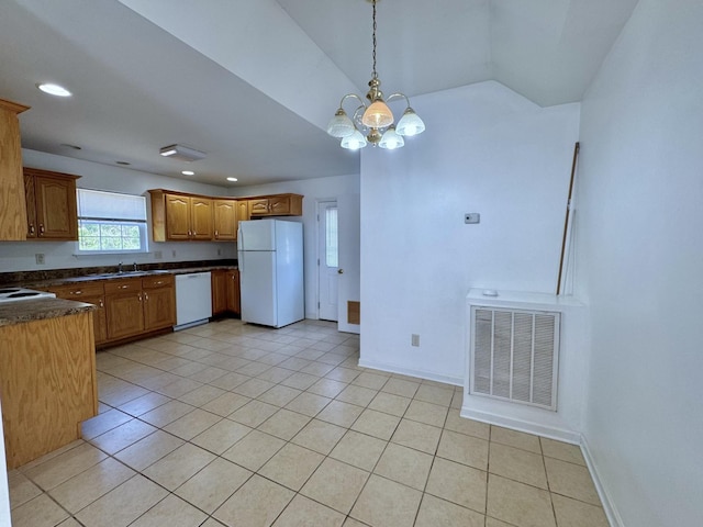 kitchen featuring dark countertops, visible vents, light tile patterned floors, white appliances, and a chandelier