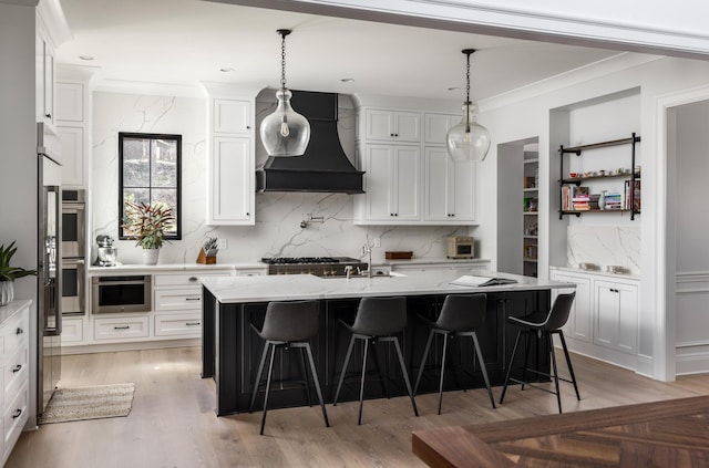 kitchen featuring custom exhaust hood, white cabinets, and ornamental molding