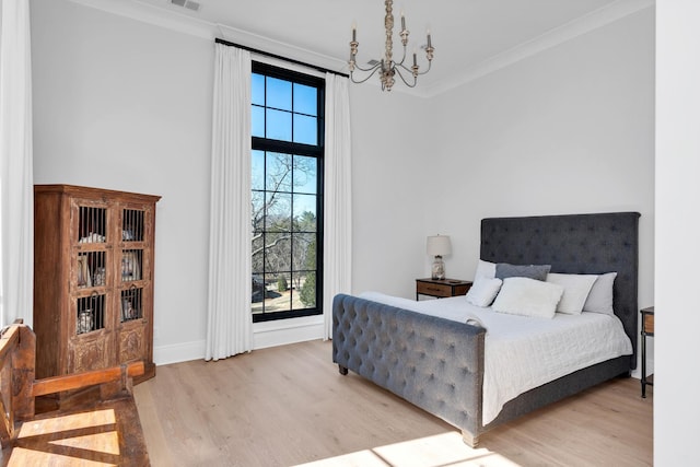 bedroom featuring light wood finished floors, a notable chandelier, multiple windows, and crown molding