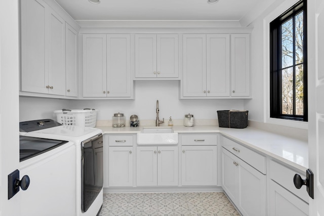 washroom featuring washer and clothes dryer, plenty of natural light, a sink, and cabinet space