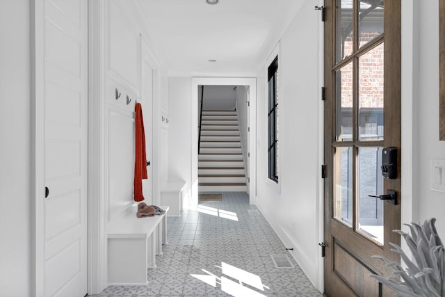 corridor featuring baseboards and stairs