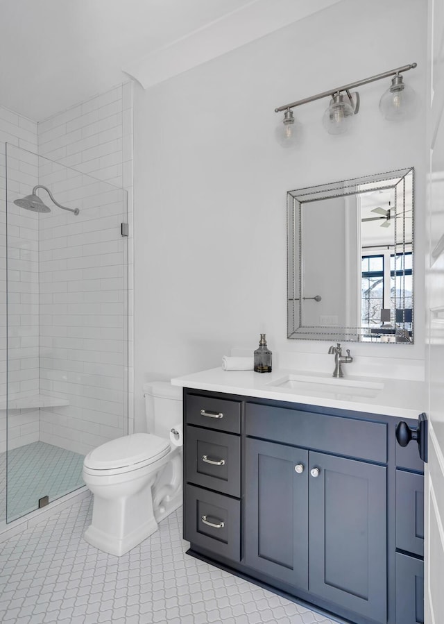 full bathroom with toilet, ceiling fan, tile patterned flooring, vanity, and a shower stall