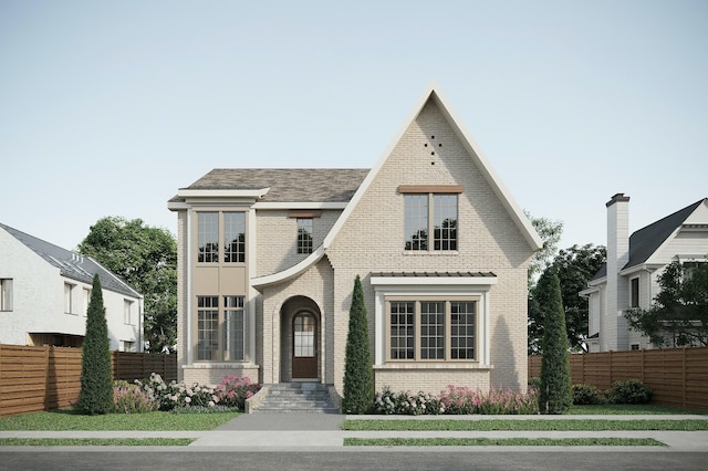 view of front of property featuring brick siding and fence