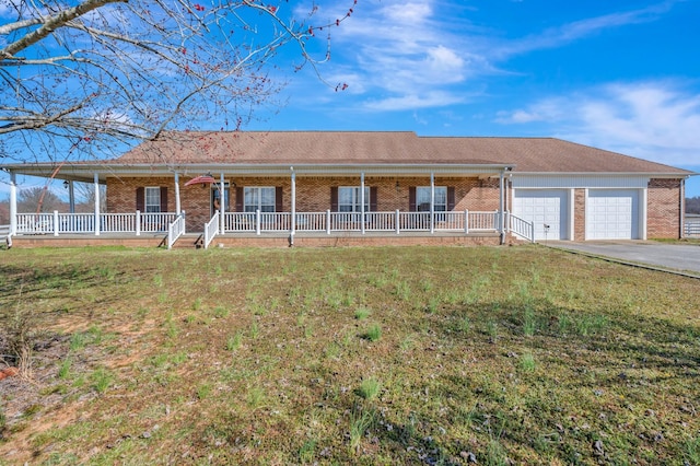 ranch-style house with aphalt driveway, brick siding, covered porch, an attached garage, and a front yard