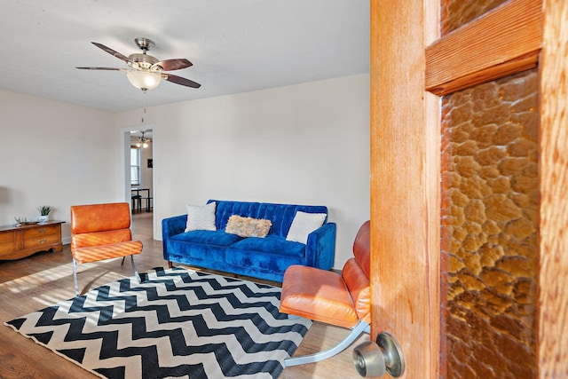 living room featuring a ceiling fan and wood finished floors