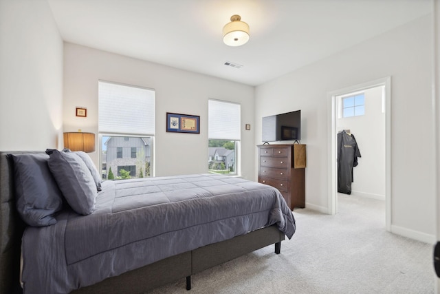 bedroom with light carpet, baseboards, and visible vents