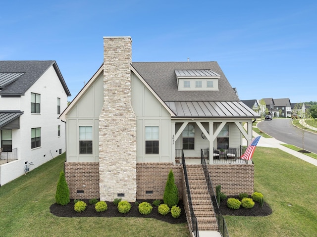 exterior space featuring roof with shingles, a chimney, a front yard, crawl space, and a standing seam roof