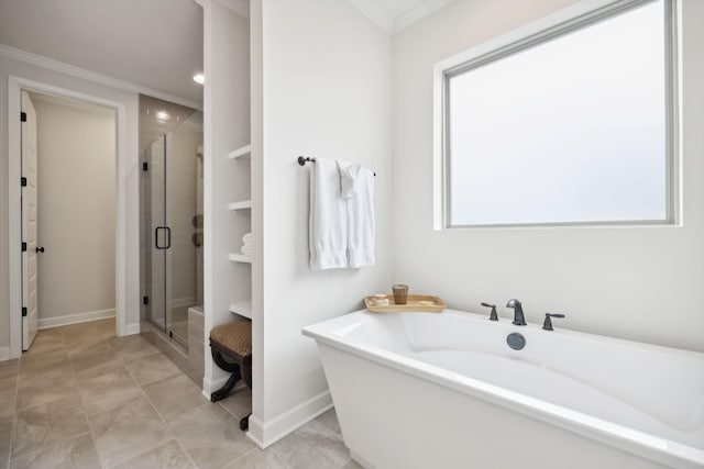 full bath with baseboards, ornamental molding, a soaking tub, tile patterned floors, and a stall shower