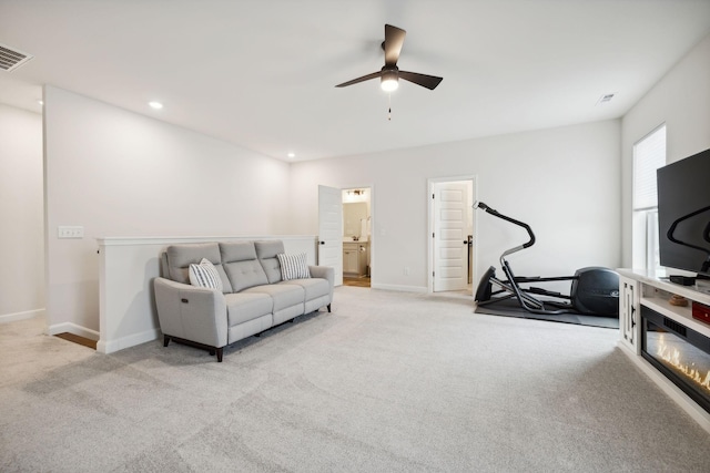 carpeted living room with visible vents, baseboards, a ceiling fan, and recessed lighting