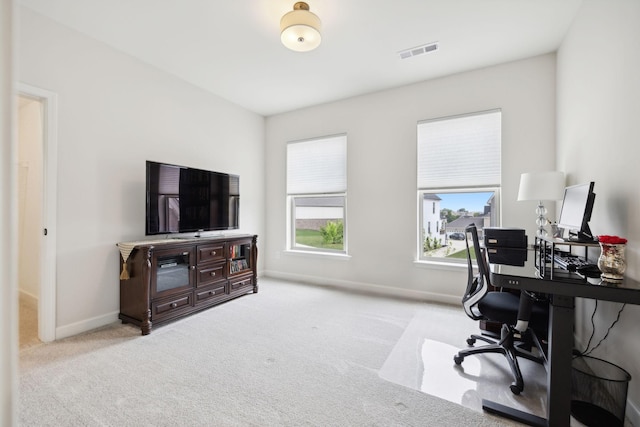 office featuring baseboards, visible vents, and carpet flooring