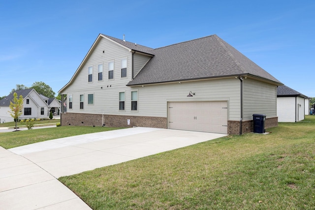 view of side of home featuring a garage, driveway, a lawn, and roof with shingles