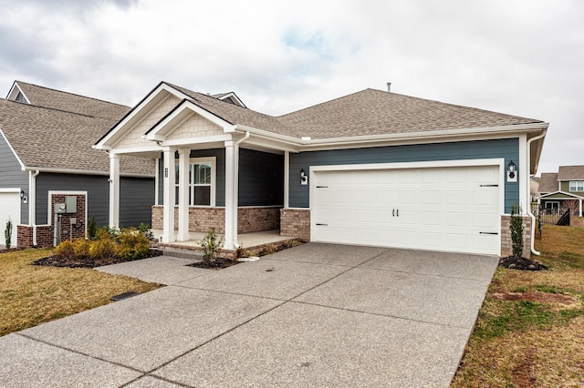 craftsman-style home with brick siding, a porch, driveway, and a shingled roof