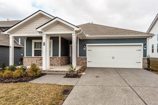 craftsman inspired home featuring a porch, a shingled roof, concrete driveway, a garage, and brick siding