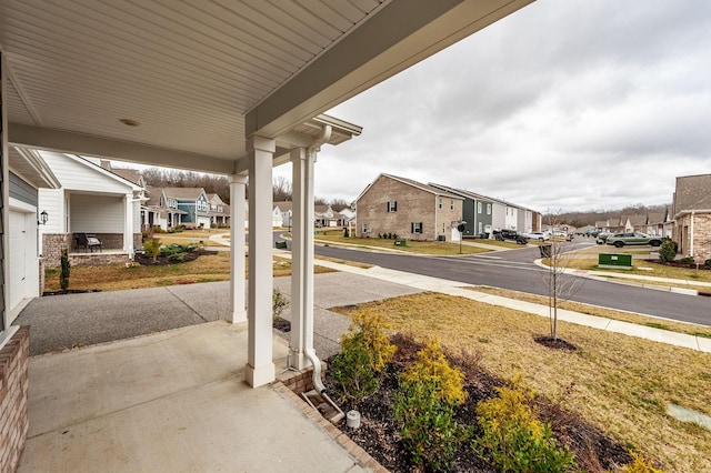 view of patio featuring covered porch and a residential view