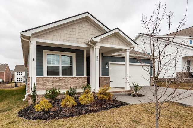 craftsman-style house with an attached garage and driveway