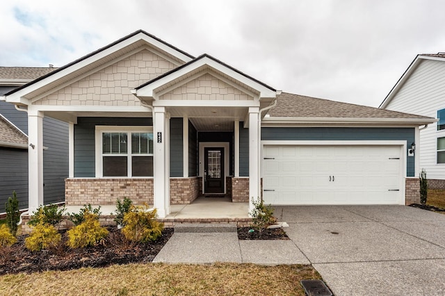 craftsman inspired home featuring a porch, an attached garage, driveway, and roof with shingles