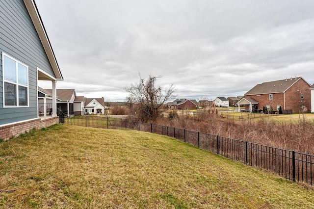 view of yard with a residential view and fence