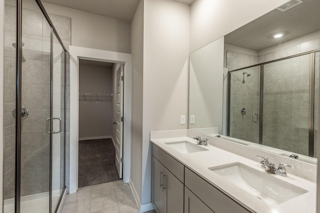 full bath with a sink, visible vents, and a stall shower