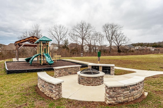 community jungle gym with a patio, a yard, and a fire pit