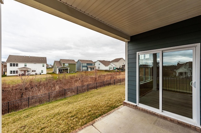 view of yard featuring a patio area, a residential view, and fence