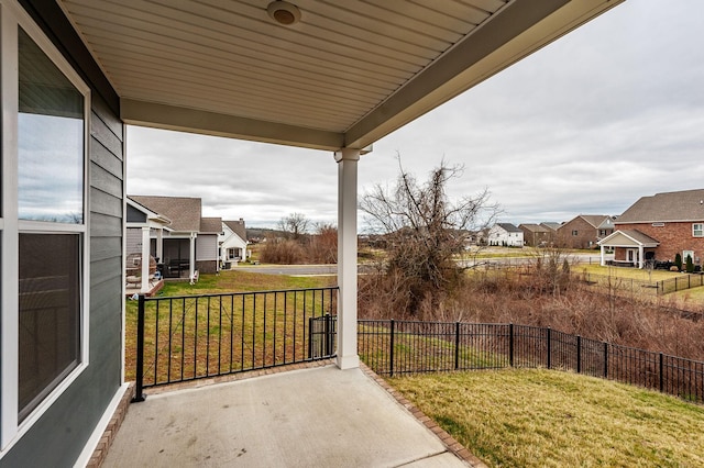 view of patio / terrace with a residential view, covered porch, and fence