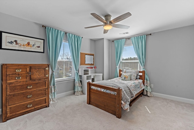 bedroom featuring carpet floors, multiple windows, visible vents, and baseboards