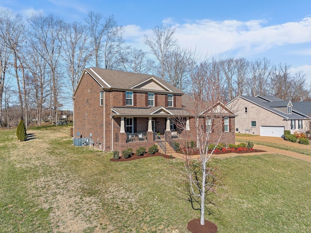 view of front of property featuring a front lawn, a porch, and brick siding