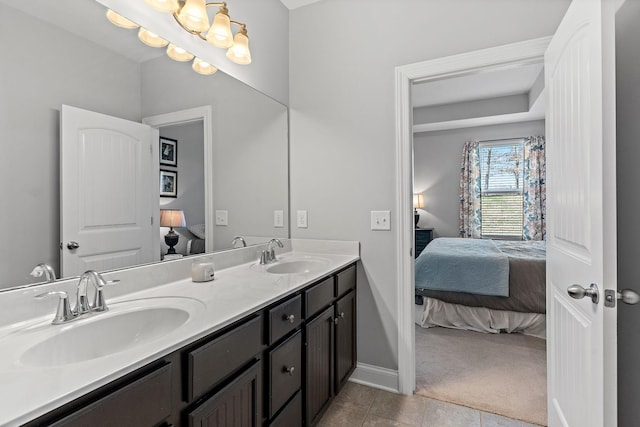 bathroom featuring a sink, double vanity, and connected bathroom