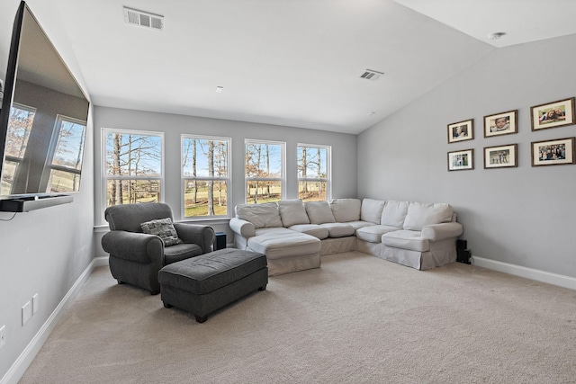 carpeted living room featuring lofted ceiling, visible vents, and baseboards