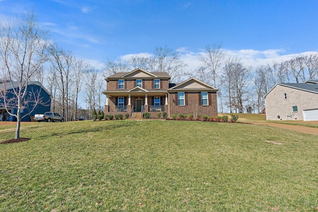 traditional-style house featuring brick siding, a porch, and a front yard