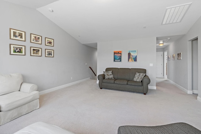 carpeted living room featuring lofted ceiling and baseboards