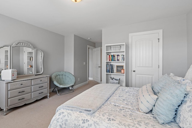 bedroom featuring light colored carpet and baseboards