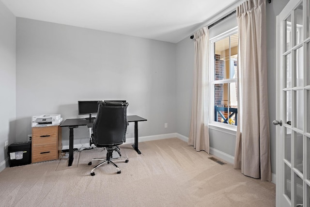 carpeted office featuring visible vents and baseboards