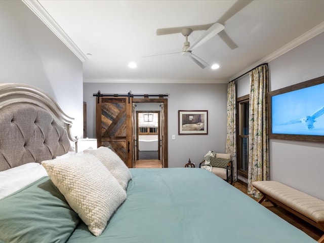 bedroom with ornamental molding, recessed lighting, and a barn door