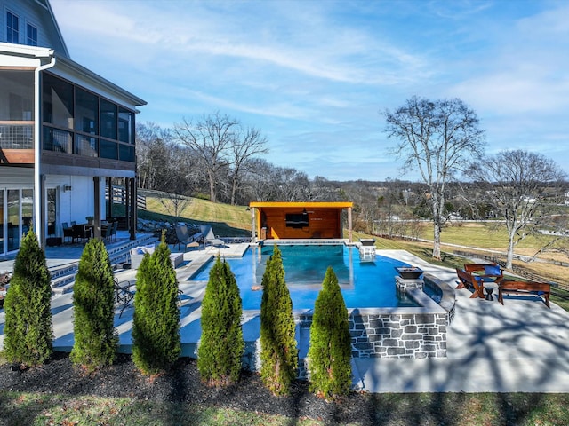 view of swimming pool featuring a patio, a swimming pool, and a sunroom