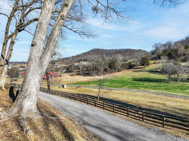 view of street with a rural view and a mountain view